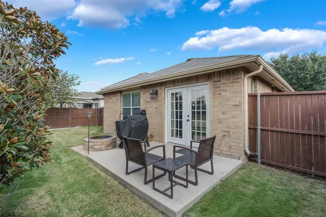 a view of backyard with outdoor seating and green space