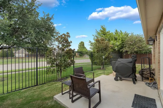 a view of a backyard with sitting area and garden