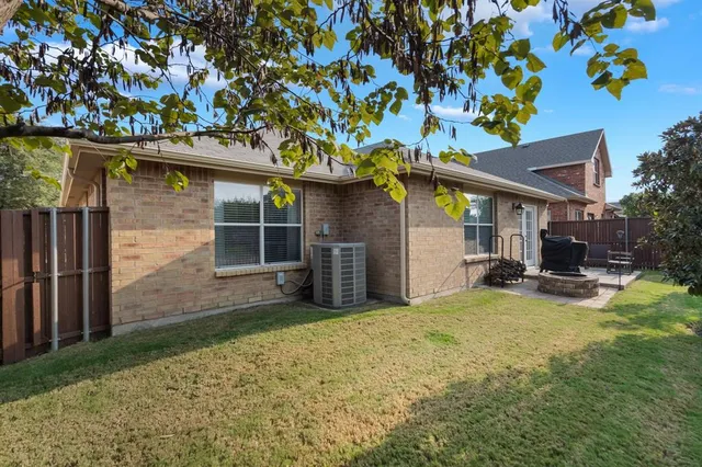 a view of a house with a patio and a yard