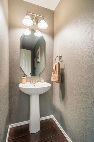 a bathroom with a sink a mirror and vanity