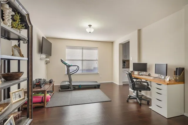 a view of a workspace with furniture and a window