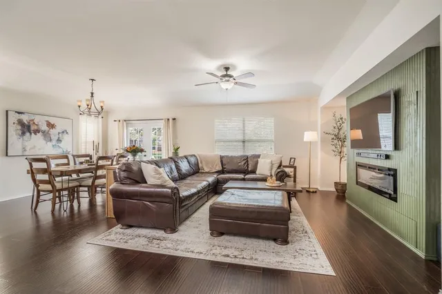 a living room with furniture or kitchen view and a wooden floor