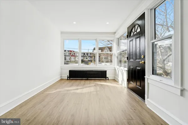 a view of a living room with furniture and wooden floor