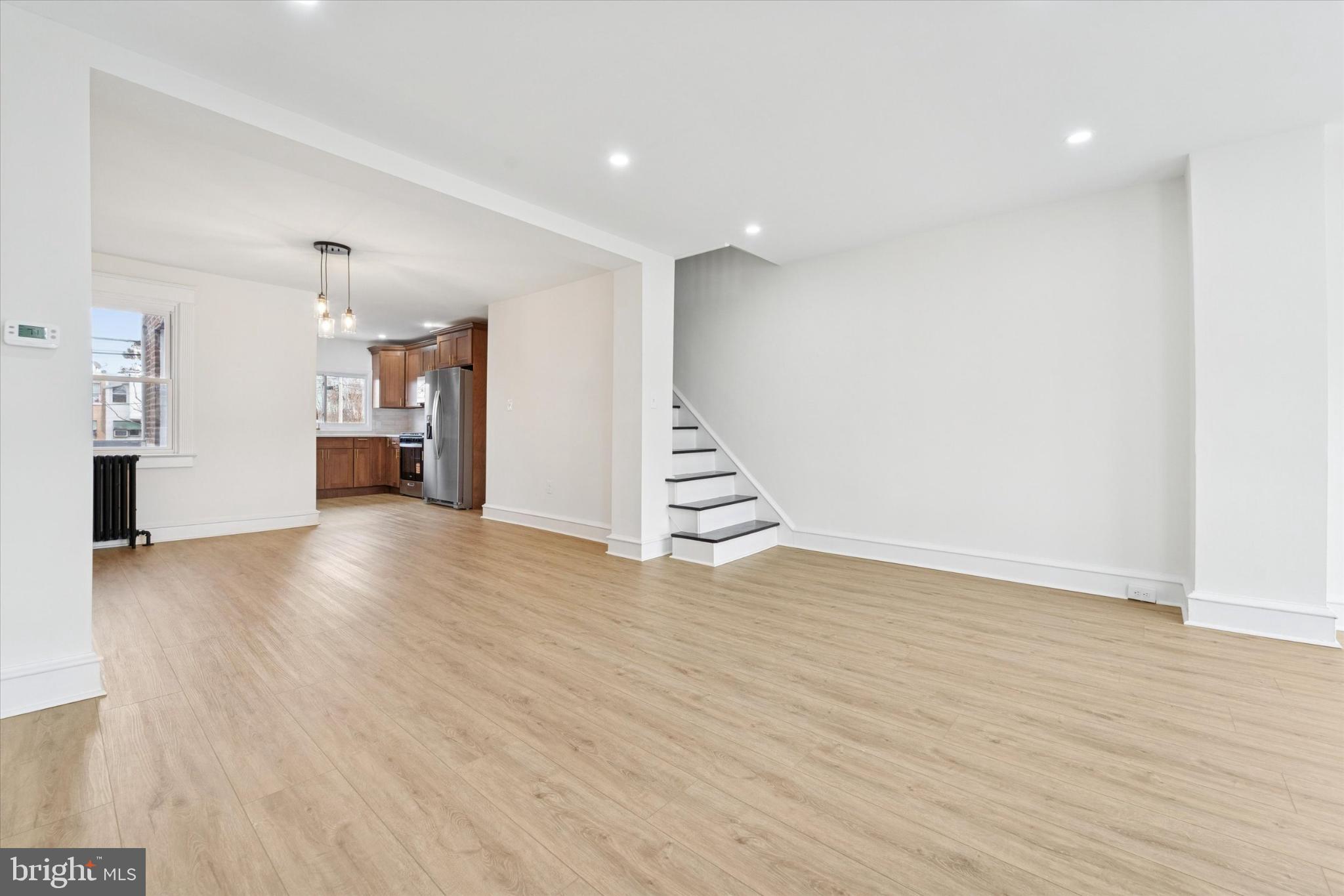 247 Coverly Road Lansdowne, PA 19050 - Photo 14 of 25 a view of an empty room with wooden floor and stairs