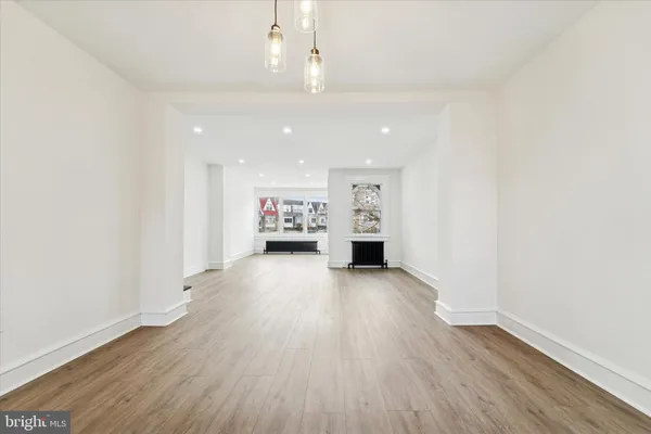 a view of kitchen with furniture and wooden floor