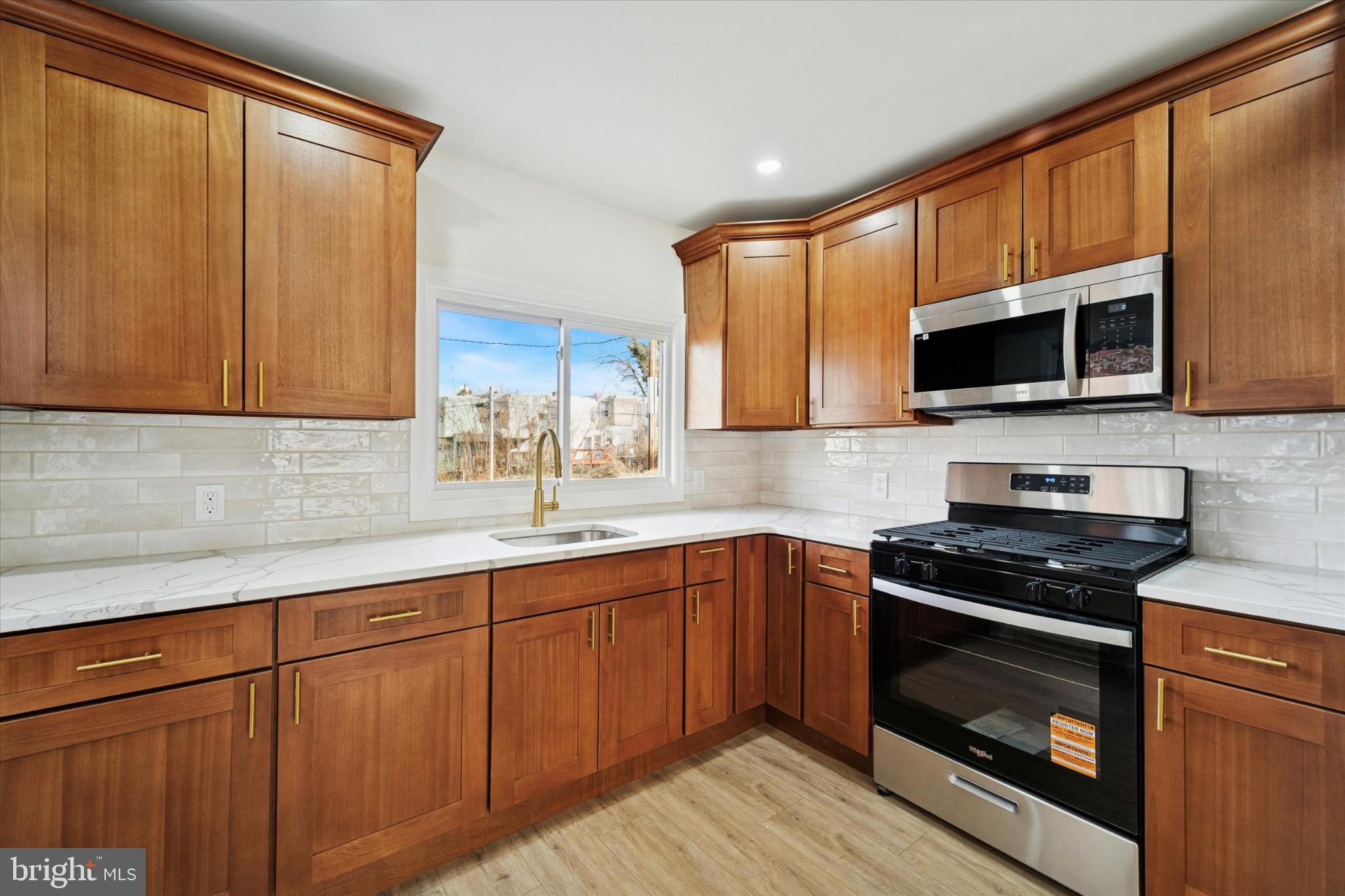247 Coverly Road Lansdowne, PA 19050 - Photo 21 of 25 a kitchen with sink a microwave and cabinets