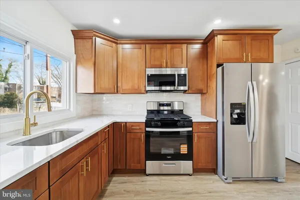 a kitchen with a sink stove and refrigerator