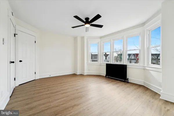 a view of cabinets and window with wooden floor