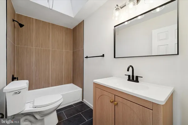 a bathroom with a sink a toilet and mirror