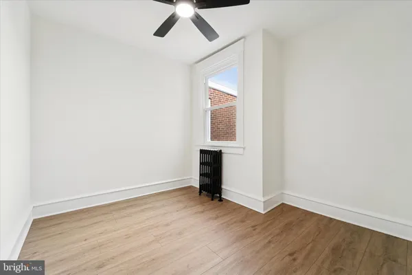 an empty room with wooden floor table and closet