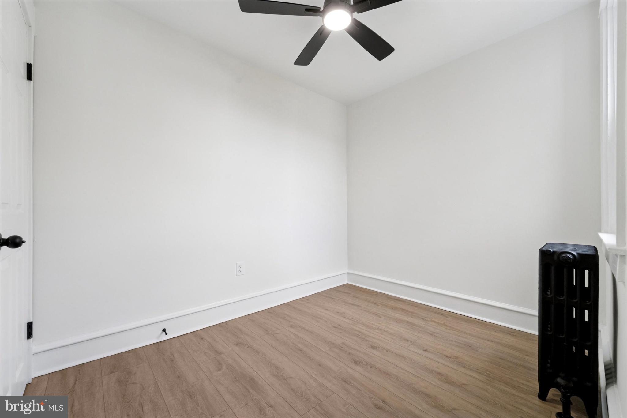 247 Coverly Road Lansdowne, PA 19050 - Photo 7 of 25 an empty room with wooden floor and windows