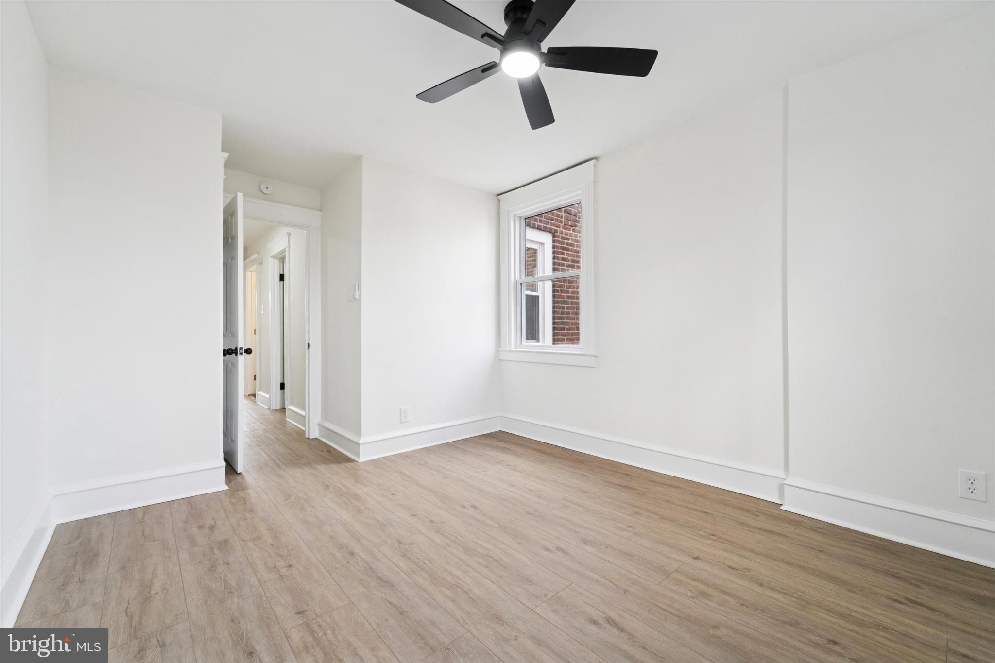 247 Coverly Road Lansdowne, PA 19050 - Photo 10 of 25 an empty room with wooden floor and ceiling fan