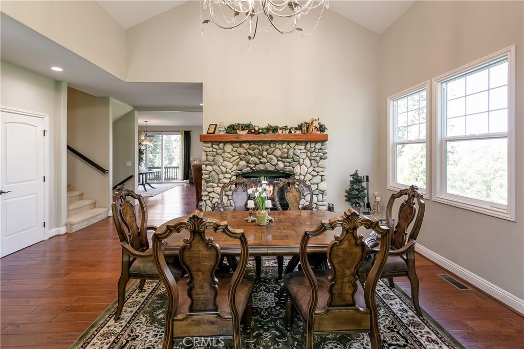 28449 Fresh Spring Lane Lake Arrowhead, CA 92352 - Photo 11 of 55 a view of a dining room with furniture window and wooden floor