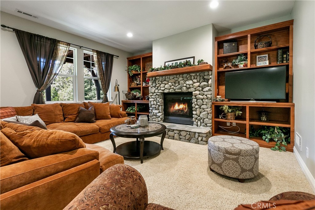 28449 Fresh Spring Lane Lake Arrowhead, CA 92352 - Photo 18 of 55 a living room with furniture flat screen tv and a fireplace