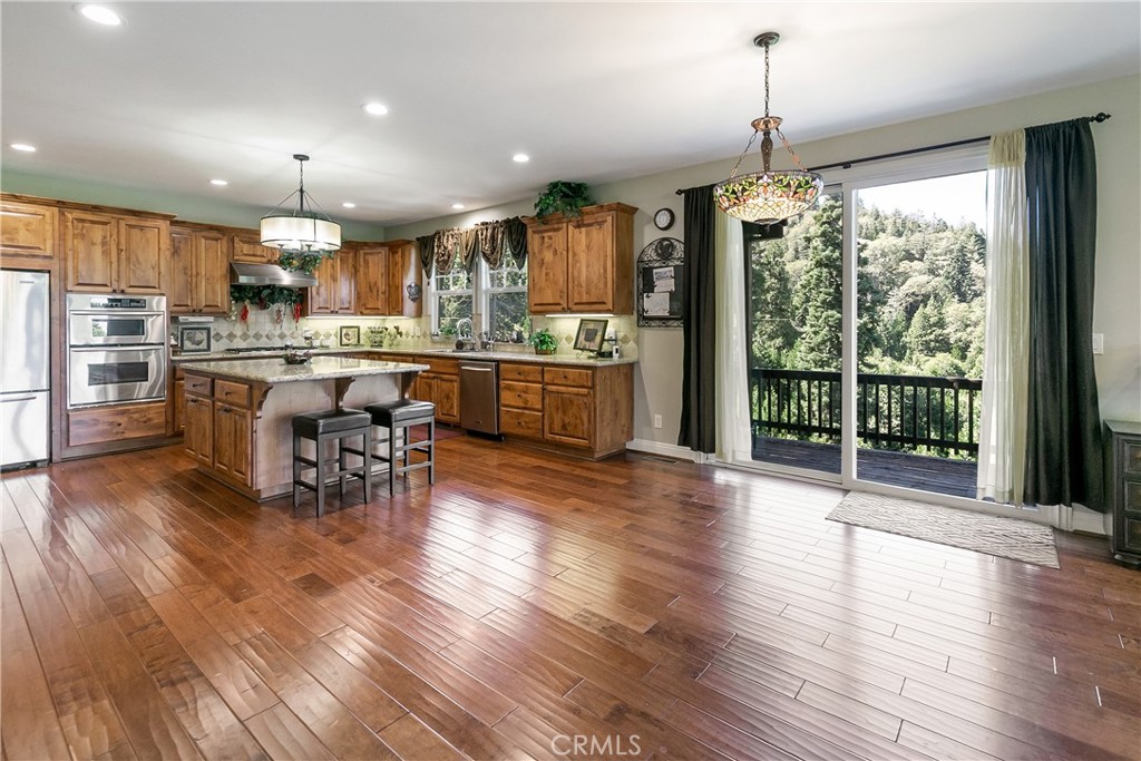 28449 Fresh Spring Lane Lake Arrowhead, CA 92352 - Photo 2 of 55 a kitchen with lots of counter top space and wooden floor