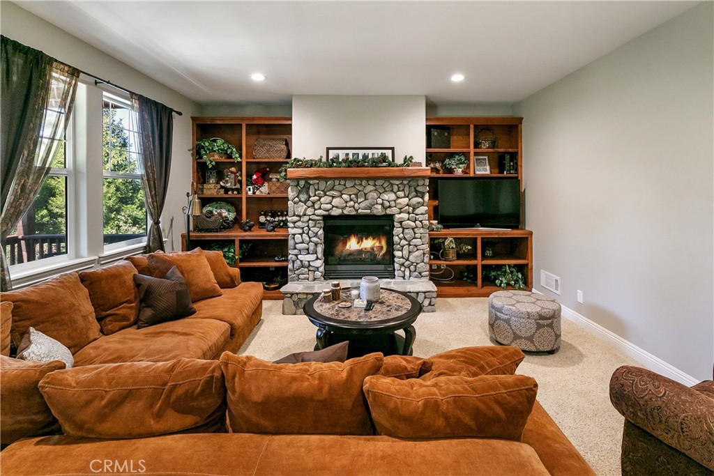 28449 Fresh Spring Lane Lake Arrowhead, CA 92352 - Photo 21 of 55 a living room with furniture fireplace and a large window