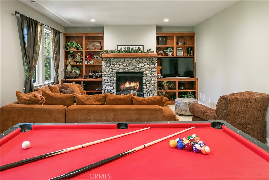 28449 Fresh Spring Lane Lake Arrowhead, CA 92352 - Photo 25 of 55 a living room with furniture a rug and a fireplace