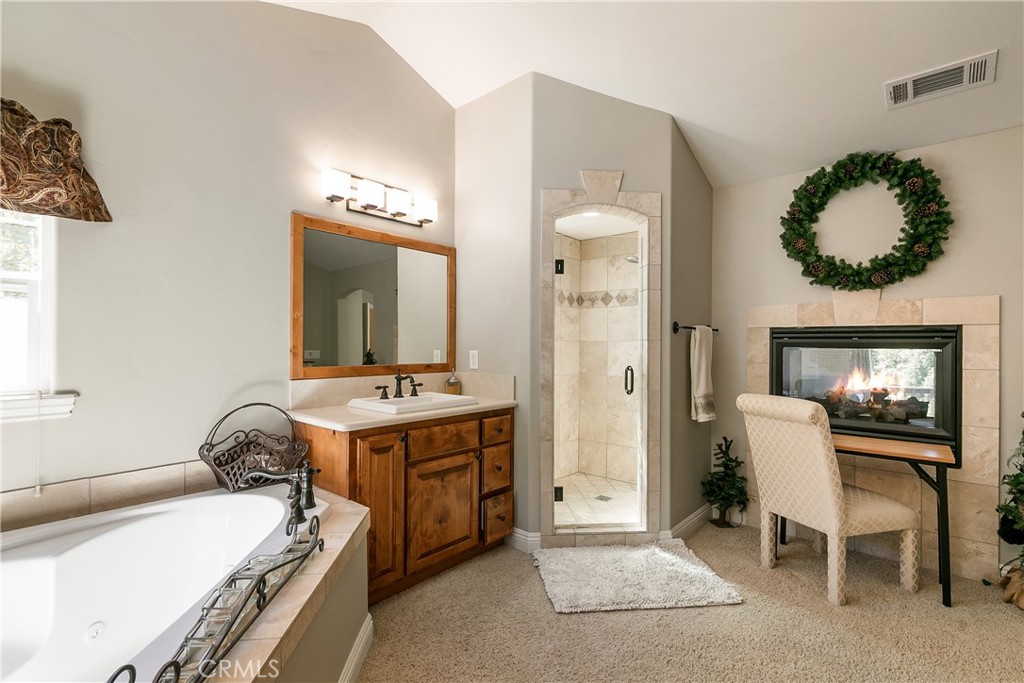 28449 Fresh Spring Lane Lake Arrowhead, CA 92352 - Photo 29 of 55 a en suite bathroom with a double vanity sink and a mirror
