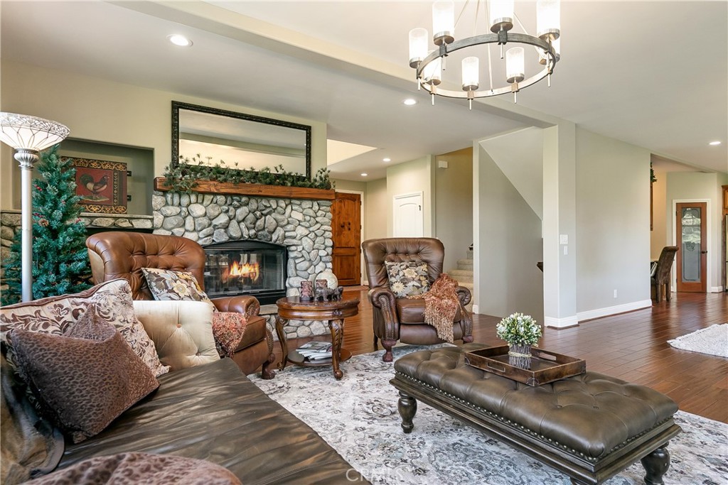 28449 Fresh Spring Lane Lake Arrowhead, CA 92352 - Photo 4 of 55 a living room with furniture and a fireplace