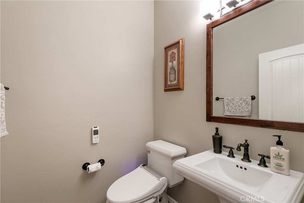 28449 Fresh Spring Lane Lake Arrowhead, CA 92352 - Photo 44 of 55 a bathroom with a sink mirror and toilet