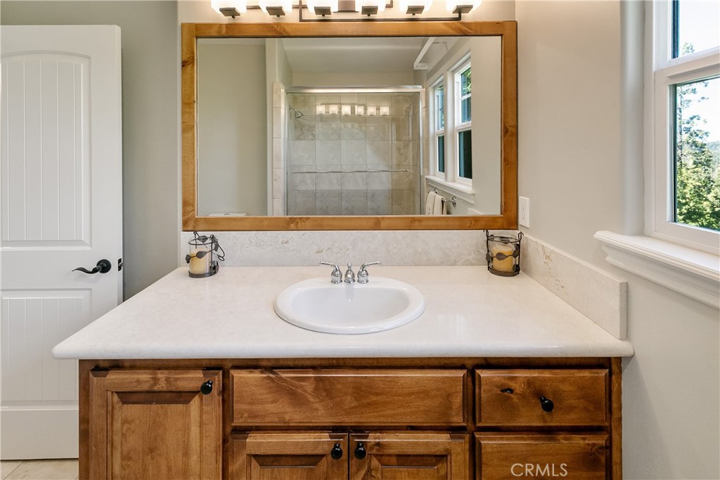 28449 Fresh Spring Lane Lake Arrowhead, CA 92352 - Photo 50 of 55 a bathroom with a sink and a mirror