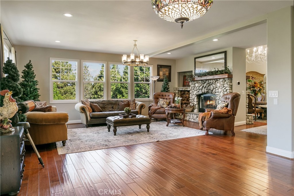 28449 Fresh Spring Lane Lake Arrowhead, CA 92352 - Photo 6 of 55 a living room with furniture and a chandelier