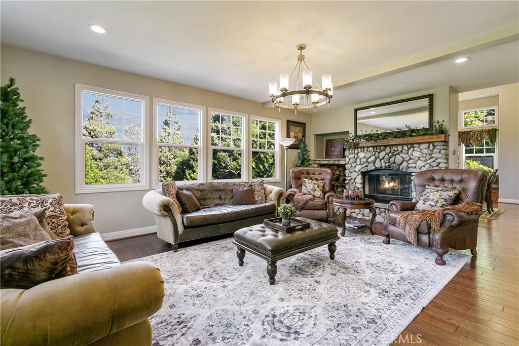 28449 Fresh Spring Lane Lake Arrowhead, CA 92352 - Photo 6 of 55 a living room with furniture fireplace and a large window