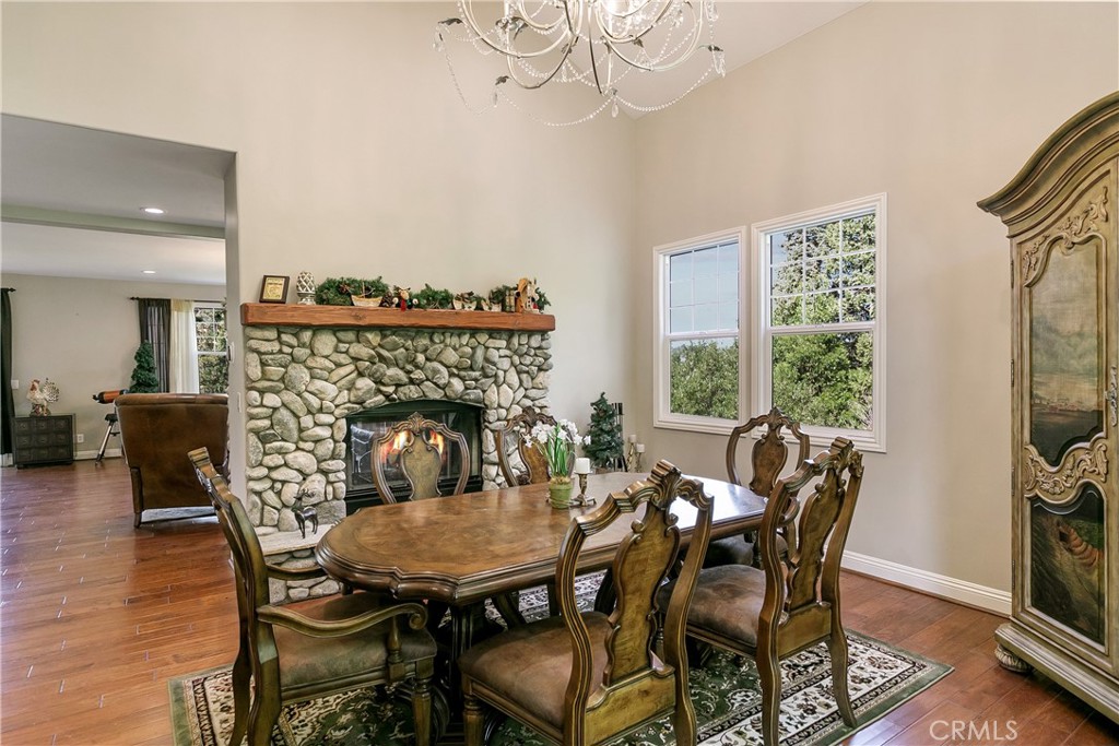 28449 Fresh Spring Lane Lake Arrowhead, CA 92352 - Photo 9 of 55 a view of a dining room with furniture window and wooden floor