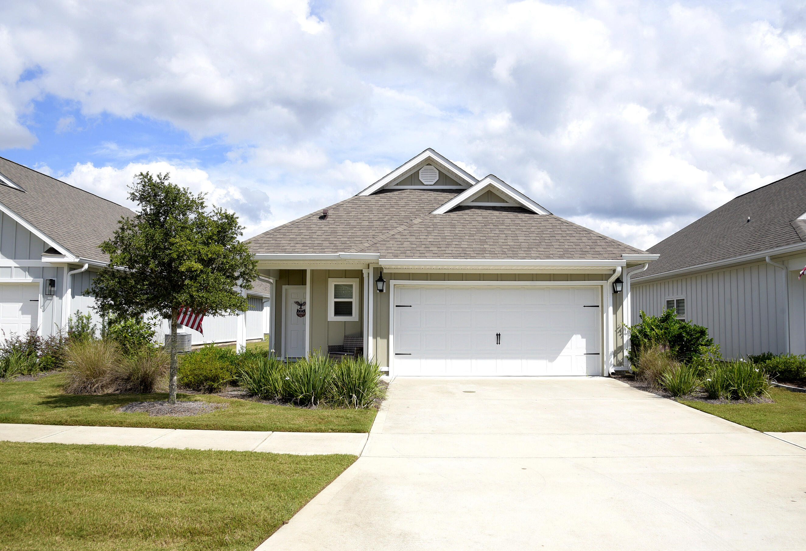 328 Lightning Bug Lane Freeport, FL 32439 - Photo 1 of 43 a front view of a house with garden