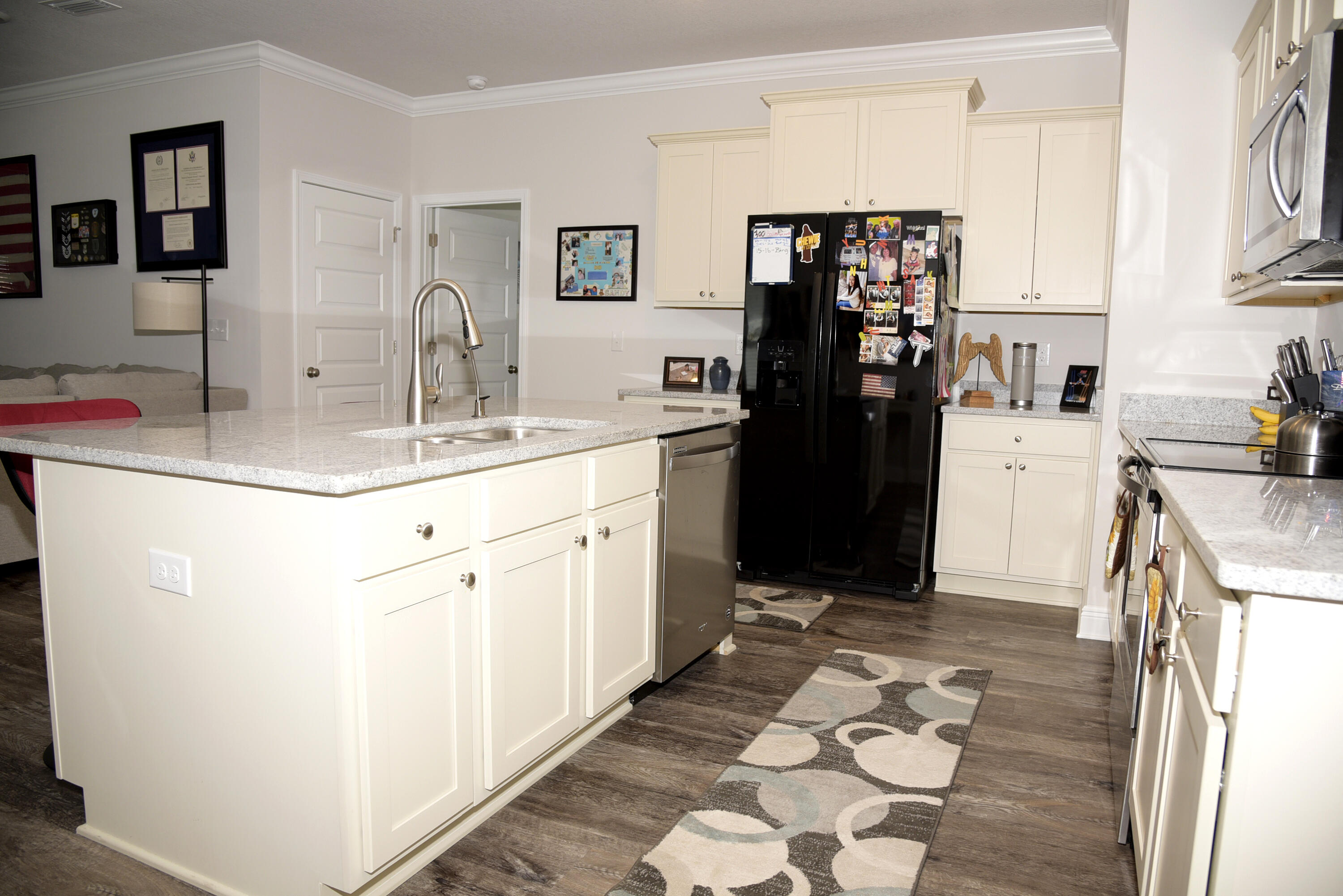328 Lightning Bug Lane Freeport, FL 32439 - Photo 13 of 43 a kitchen with a sink and cabinets