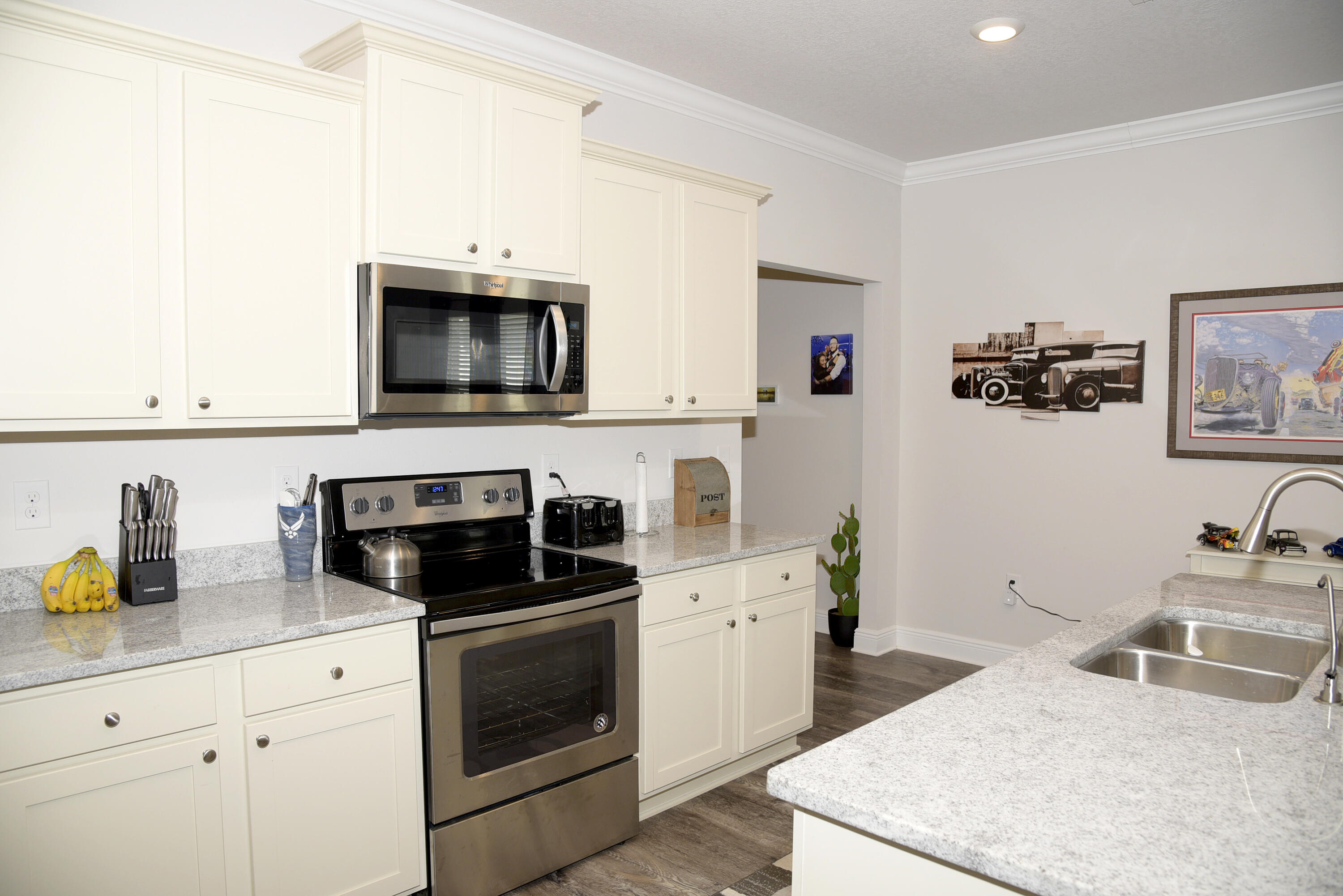 328 Lightning Bug Lane Freeport, FL 32439 - Photo 16 of 43 a kitchen with stainless steel appliances a stove a sink a microwave and cabinets