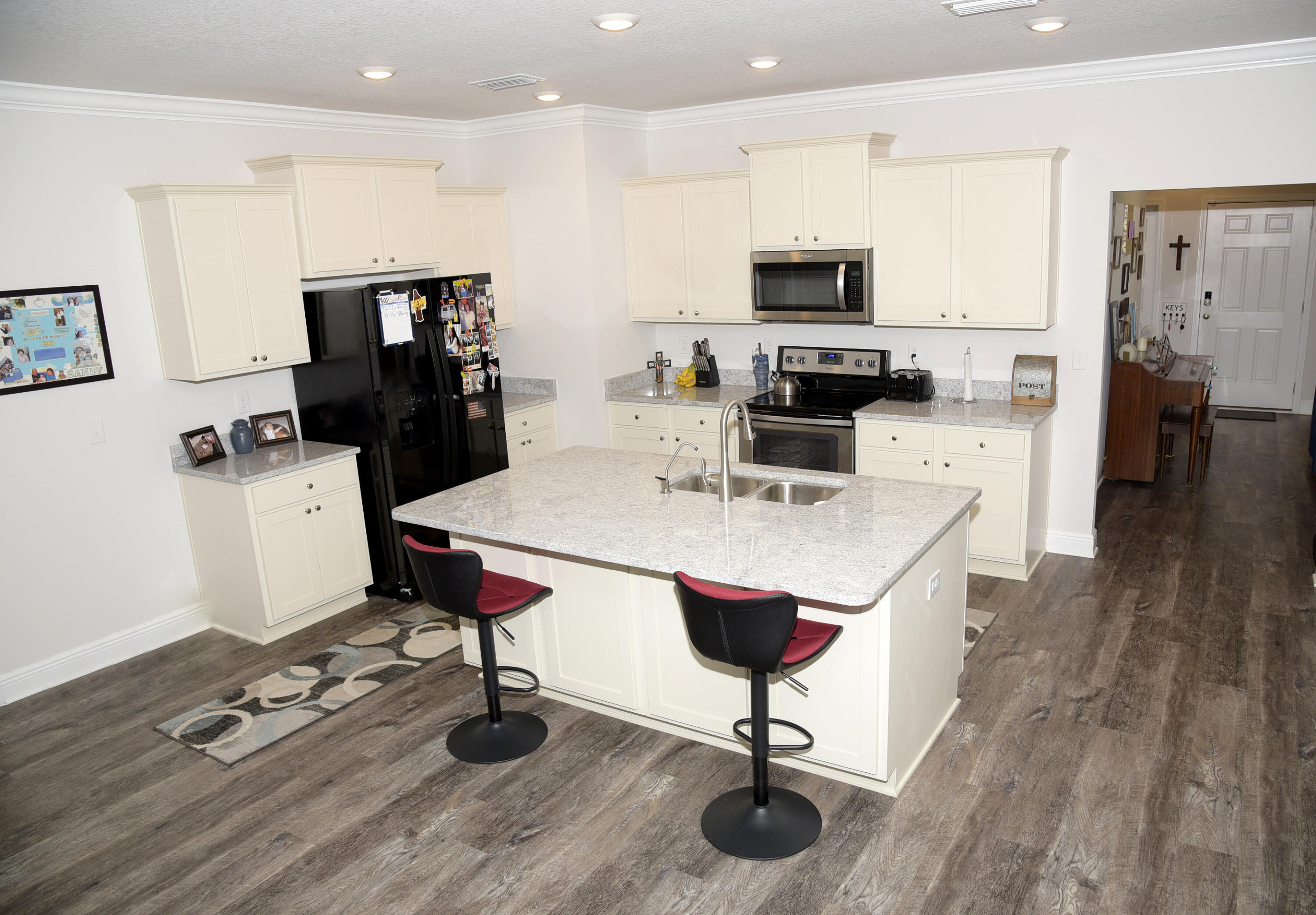 328 Lightning Bug Lane Freeport, FL 32439 - Photo 17 of 43 a living room with furniture a flat screen tv and kitchen view