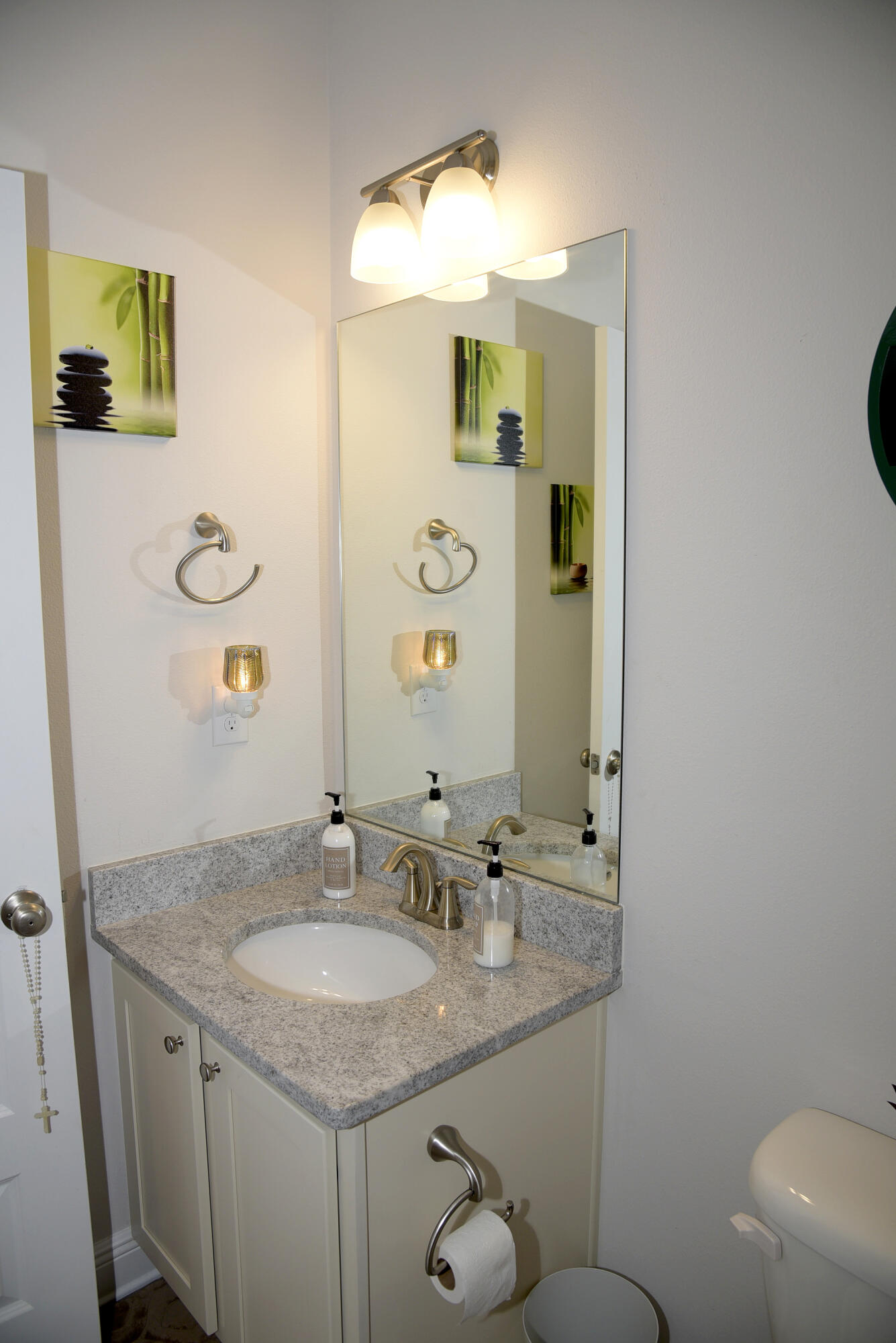 328 Lightning Bug Lane Freeport, FL 32439 - Photo 33 of 43 a bathroom with a granite countertop sink a toilet and mirror