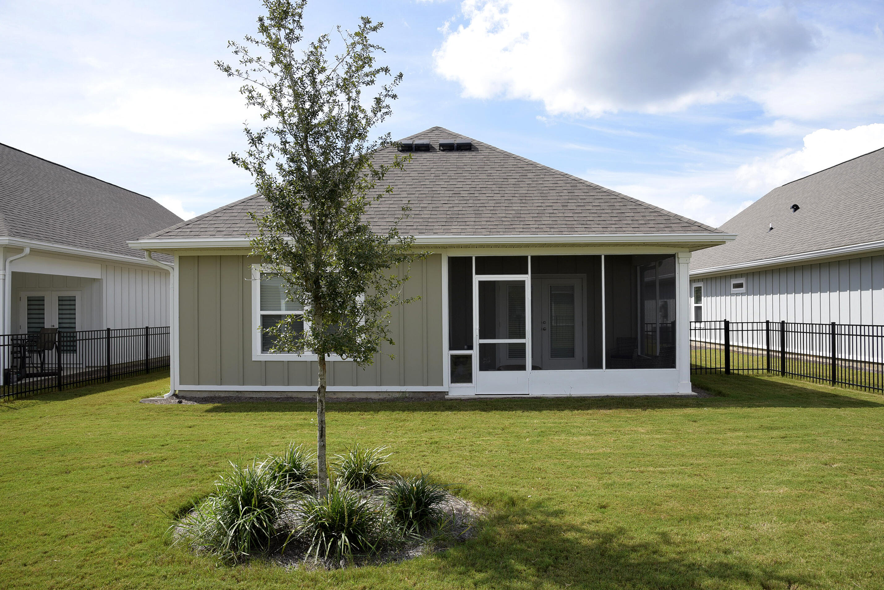 328 Lightning Bug Lane Freeport, FL 32439 - Photo 42 of 43 a house that has a big yard with potted plants