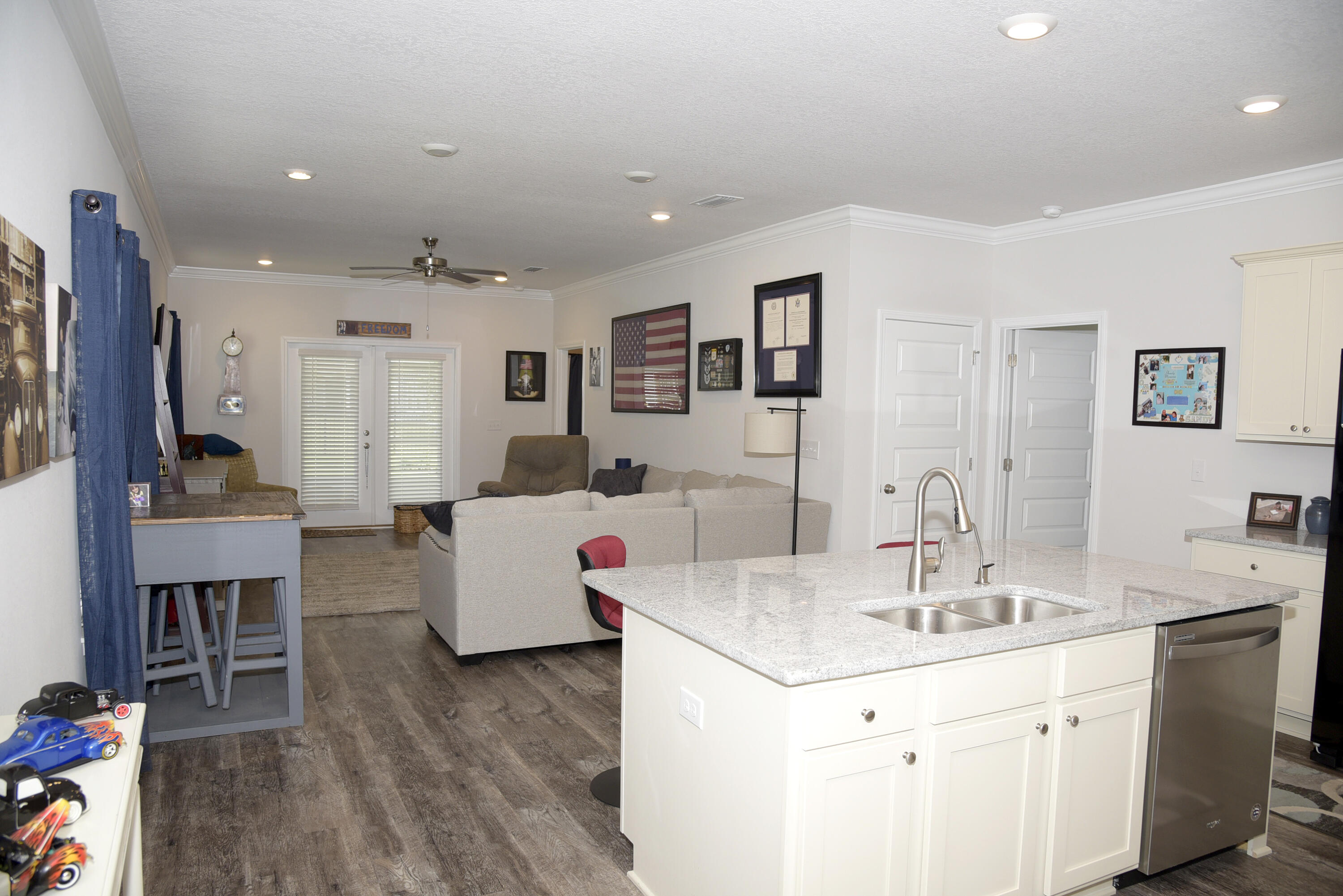 328 Lightning Bug Lane Freeport, FL 32439 - Photo 9 of 43 a kitchen with sink refrigerator and cabinets