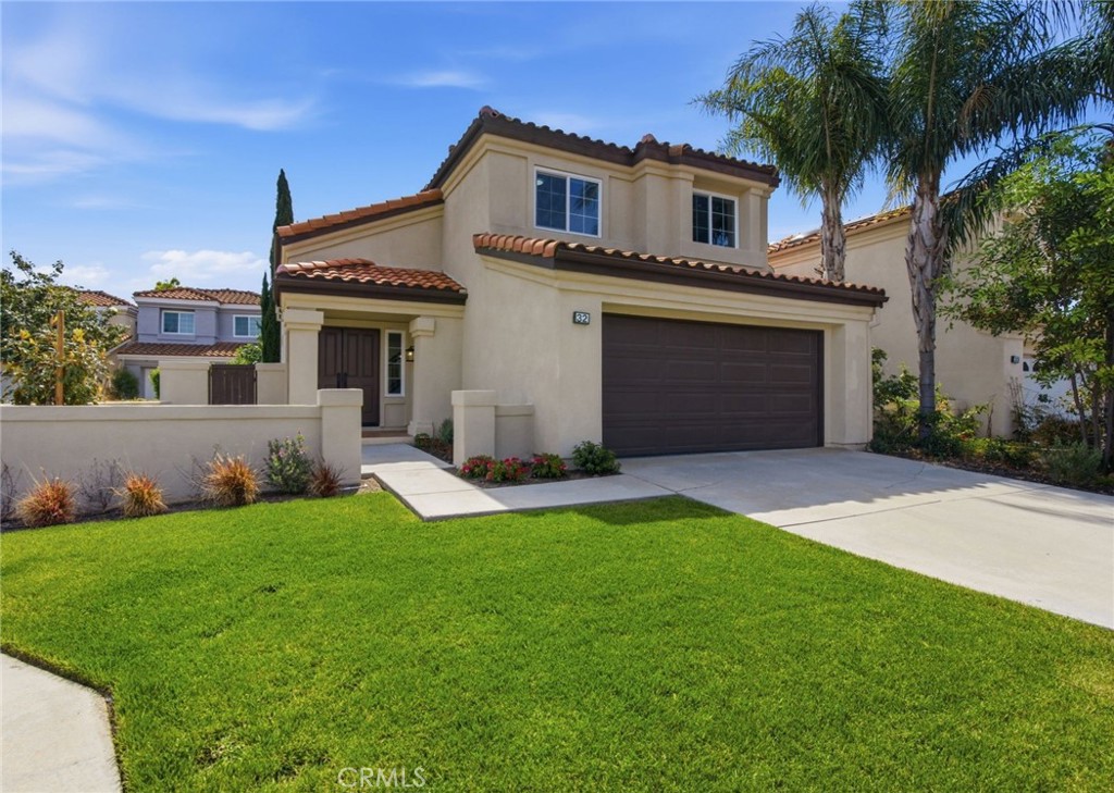 32 Comiso Irvine, CA 92614 - Photo 1 of 22 a front view of a house with a yard and garage