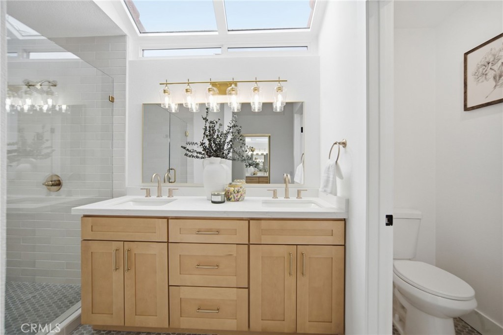 32 Comiso Irvine, CA 92614 - Photo 17 of 22 a bathroom with a granite countertop sink a toilet and a mirror
