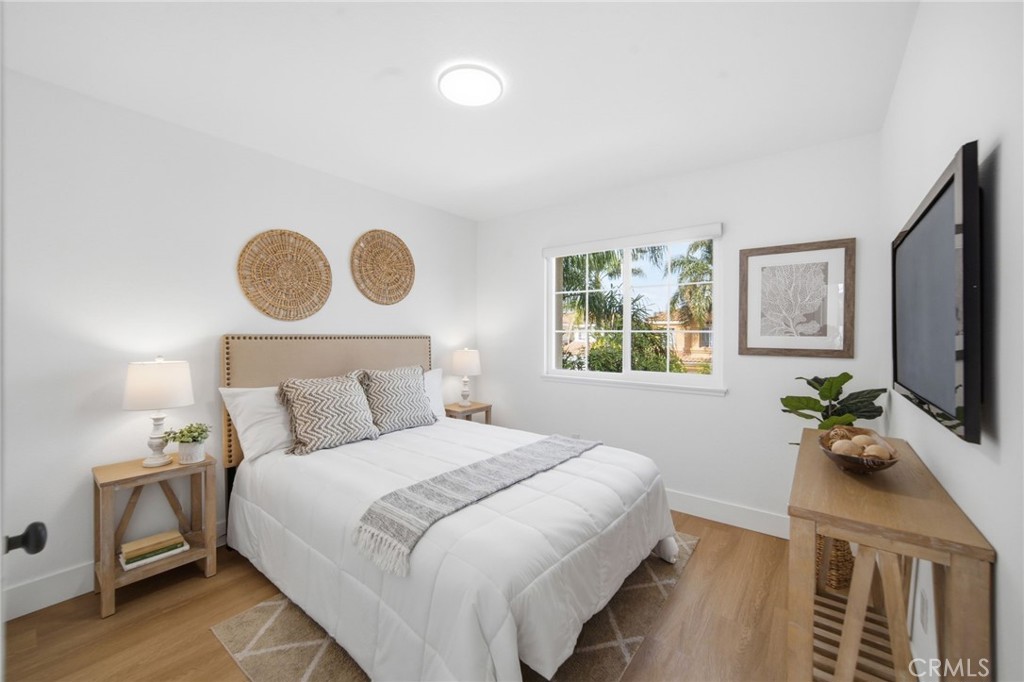 32 Comiso Irvine, CA 92614 - Photo 19 of 22 a bedroom with a bed and a flat tv screen on dresser