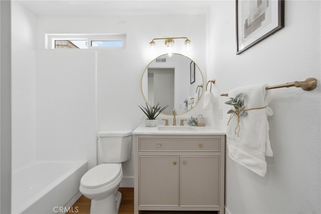 32 Comiso Irvine, CA 92614 - Photo 21 of 22 a bathroom with a sink a toilet and mirror
