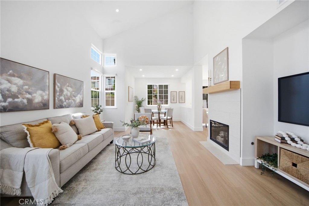 32 Comiso Irvine, CA 92614 - Photo 3 of 22 a living room with furniture flat screen tv and a fireplace