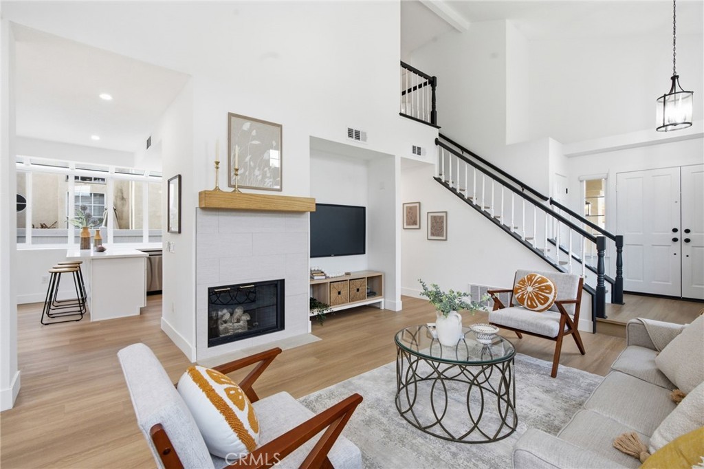 32 Comiso Irvine, CA 92614 - Photo 5 of 22 a living room with furniture a fireplace and a flat screen tv