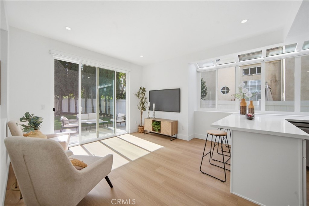 32 Comiso Irvine, CA 92614 - Photo 7 of 22 a living room with furniture a flat screen tv and a large window