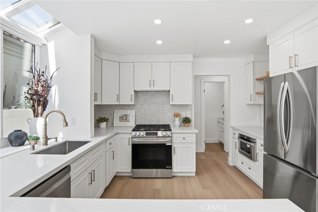 32 Comiso Irvine, CA 92614 - Photo 9 of 22 a kitchen with stainless steel appliances a refrigerator sink and stove