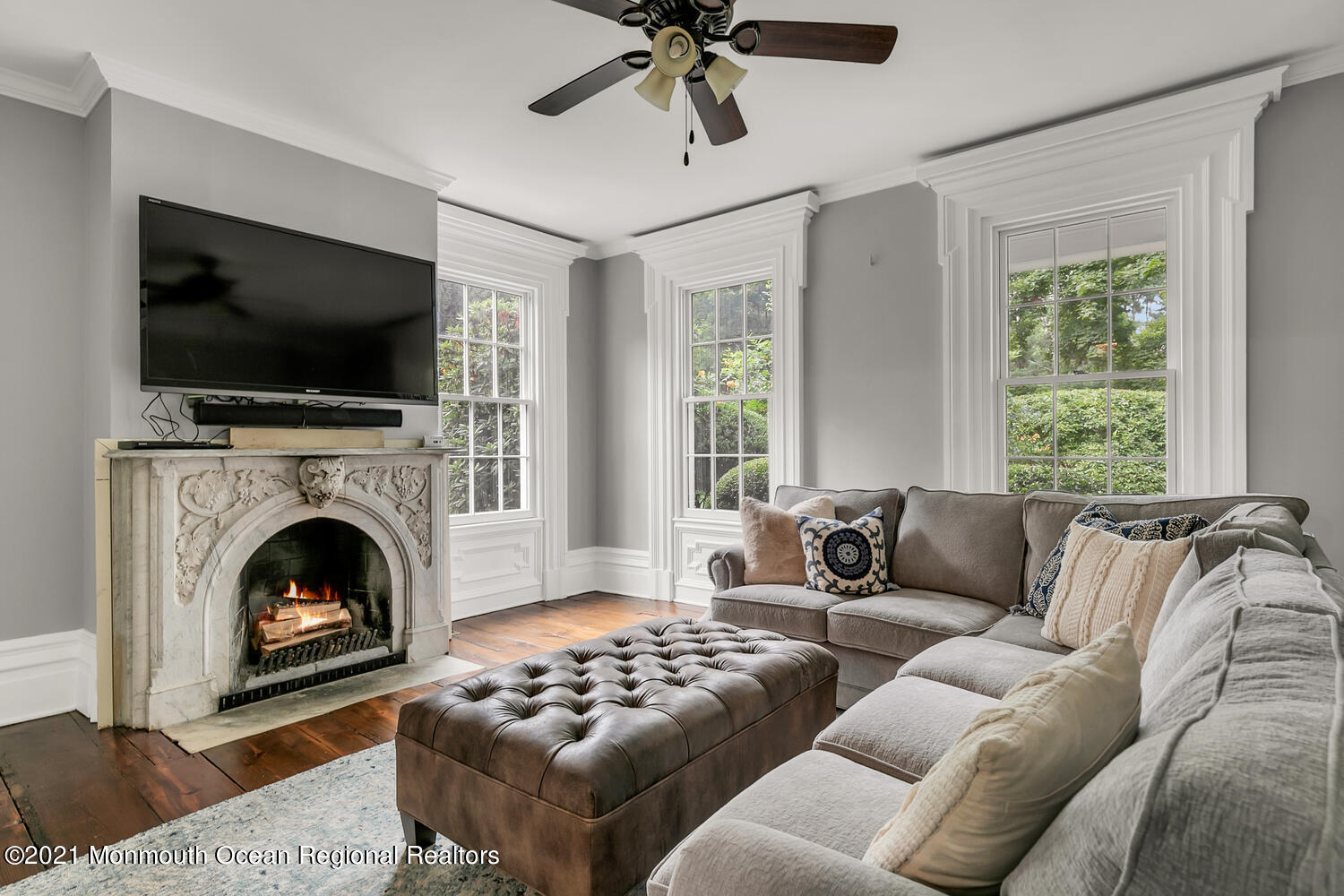 60 Conover Road Colts Neck, NJ 07722 - Photo 24 of 44 a living room with furniture a flat screen tv and a fireplace