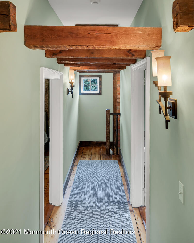 60 Conover Road Colts Neck, NJ 07722 - Photo 29 of 44 a view of a hallway with wooden floor and staircase
