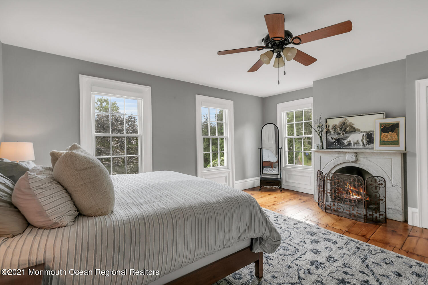 60 Conover Road Colts Neck, NJ 07722 - Photo 30 of 44 a spacious bedroom with a bed a fireplace and a window