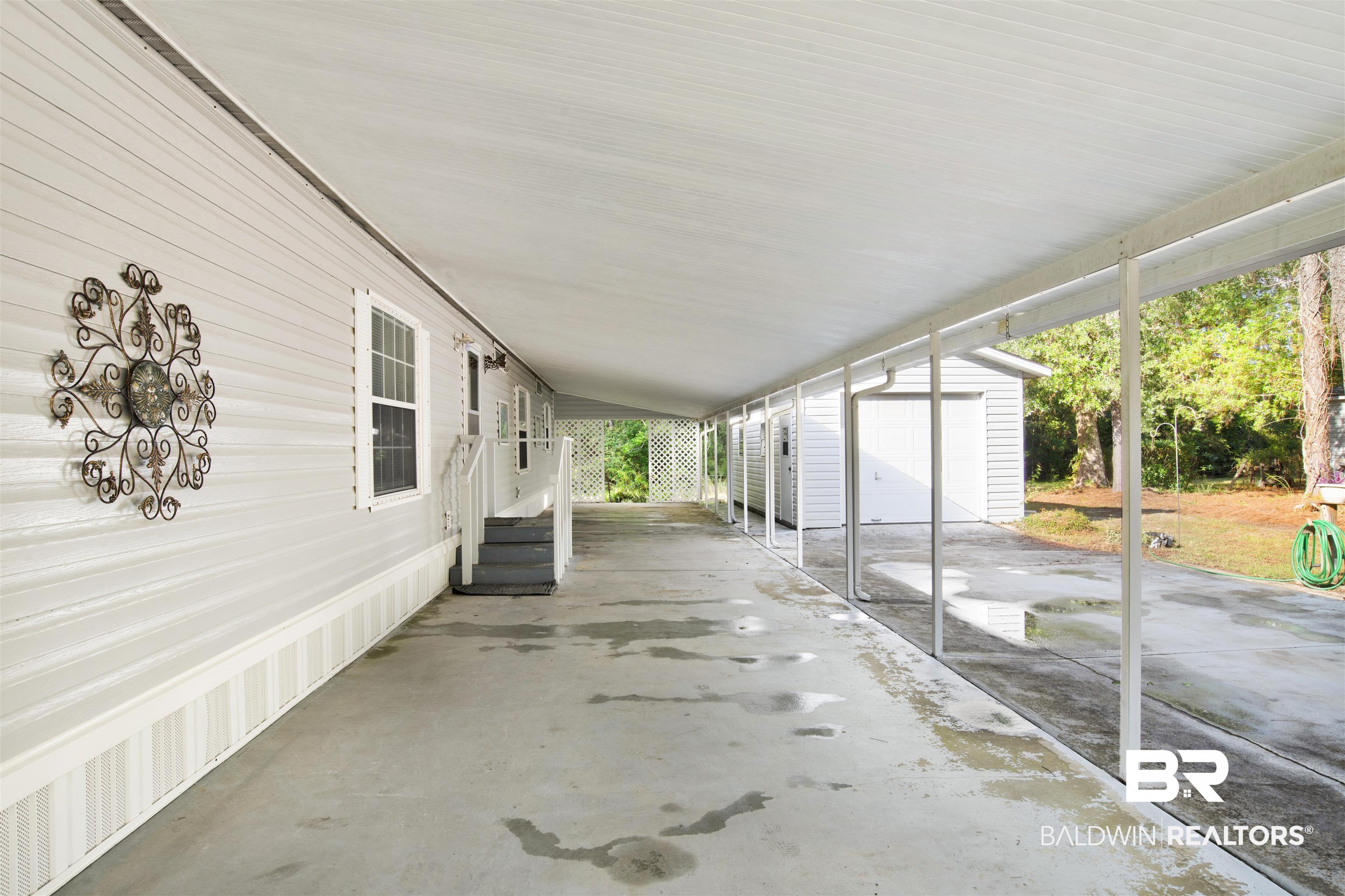 1216 Ridgewood Drive Lillian, AL 36549 - Photo 17 of 29 View of patio / terrace featuring a garage and an outdoor structure