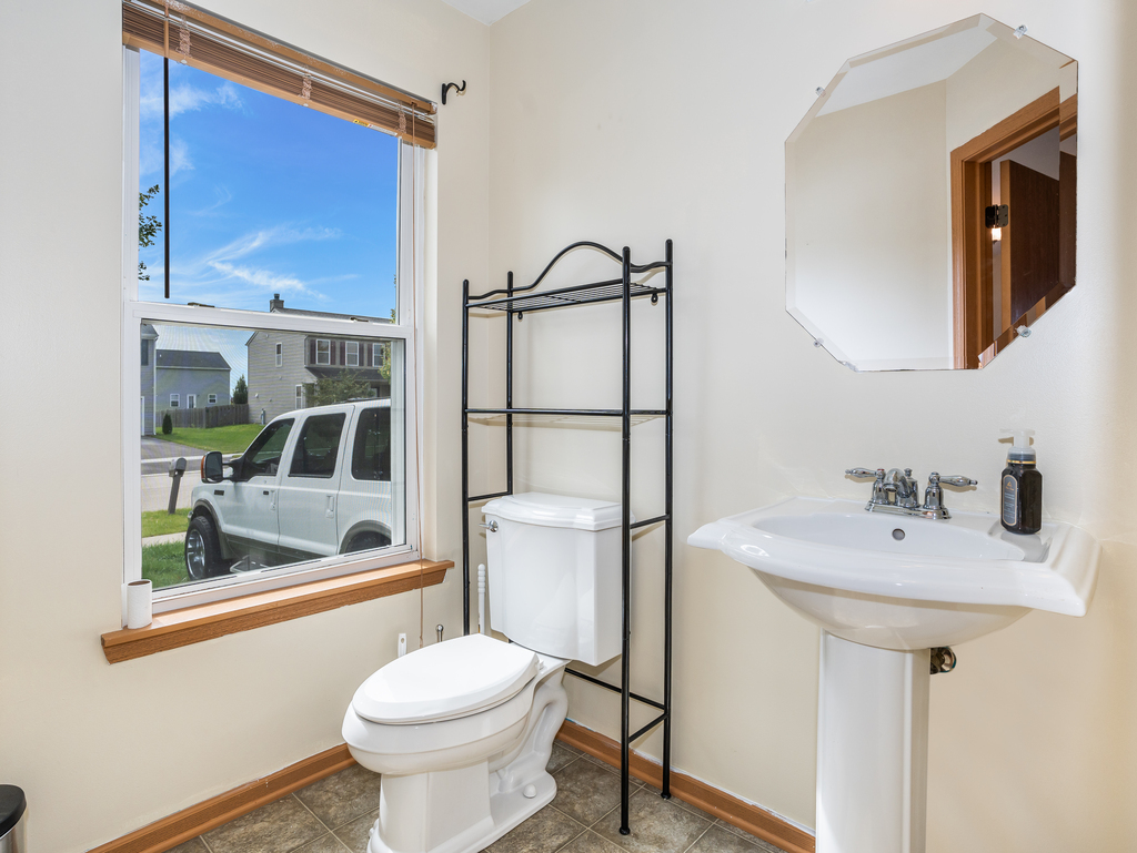 816 Kennedy Street Waterman, IL 60556 - Photo 12 of 27 a bathroom with a sink a toilet and shower