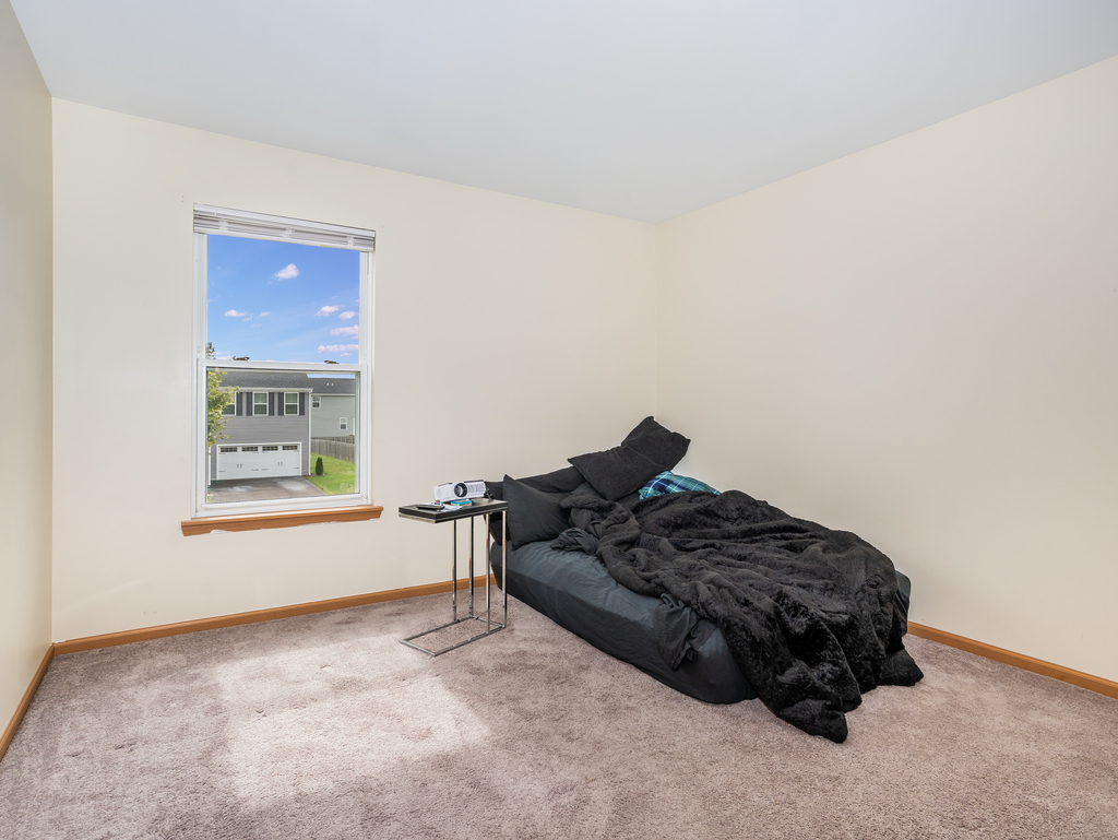 816 Kennedy Street Waterman, IL 60556 - Photo 18 of 27 a bed sitting in a bedroom next to a window