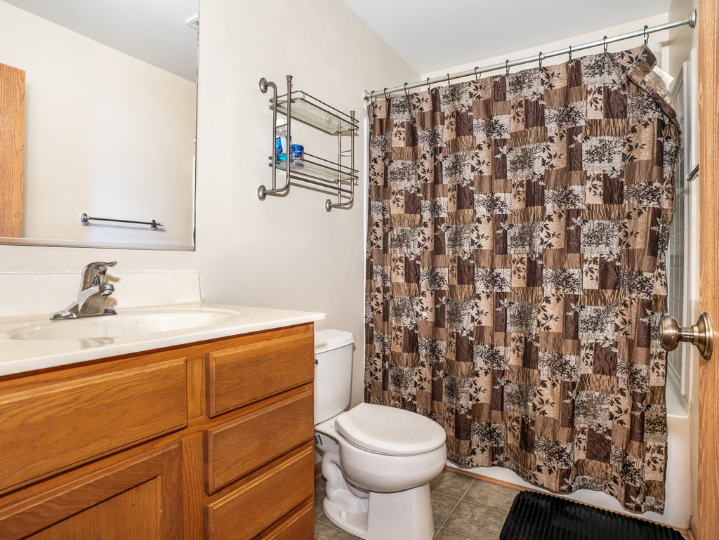 816 Kennedy Street Waterman, IL 60556 - Photo 20 of 27 a bathroom with a granite countertop sink toilet and shower